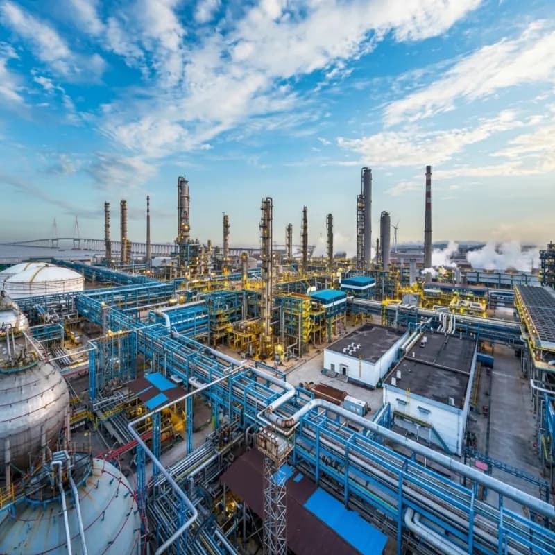 Aerial view of a gas processing plant with spherical storage tanks, pipe racks and process columns